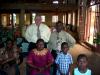 Bro. Mickey fellowshiping with some of the church members.  Note that there is no glass in any of the windows.